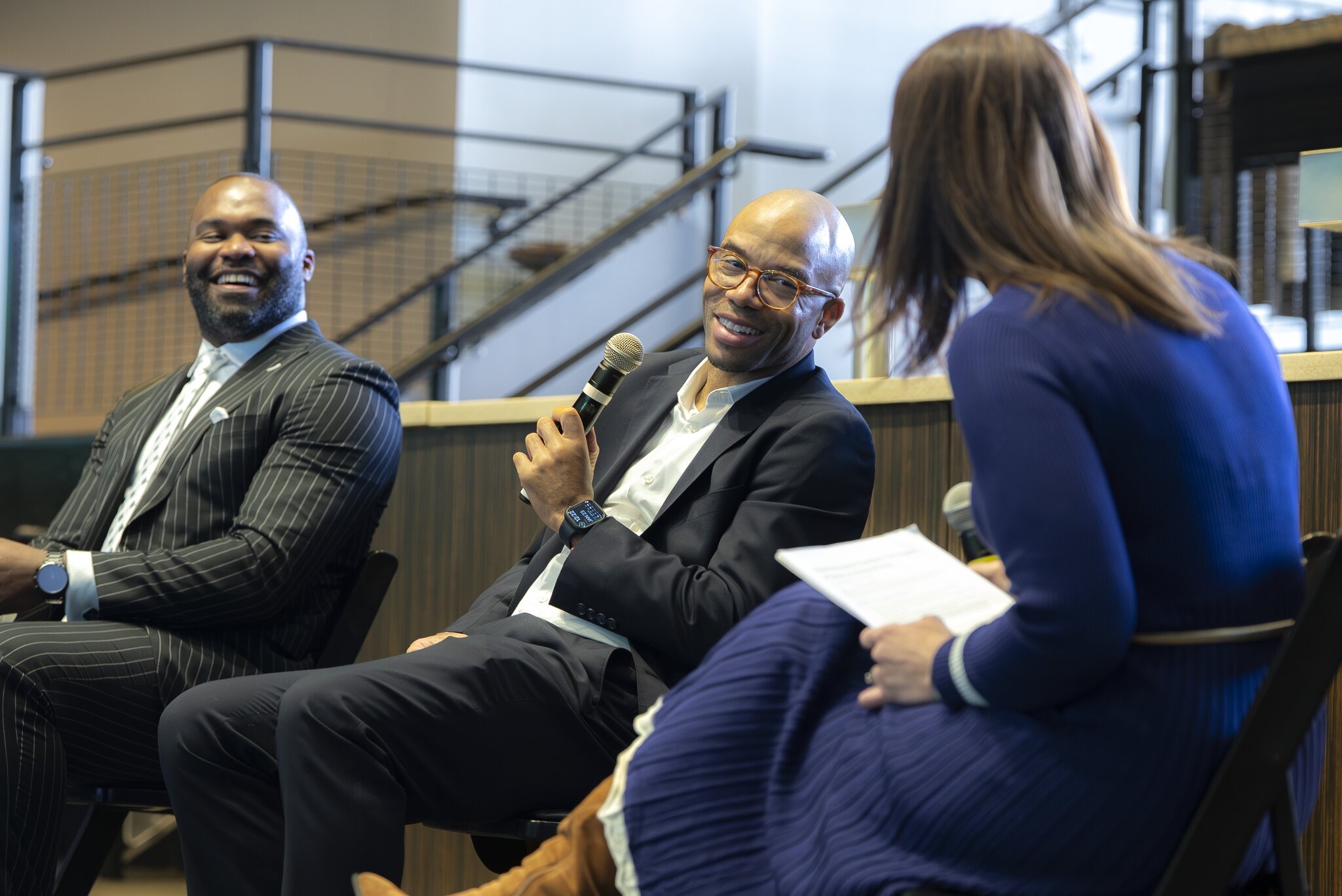 Dr. Meghan Walls interviewing Dr. Myron Rolle and Adam Taliaferro at a Sports Wellness Event